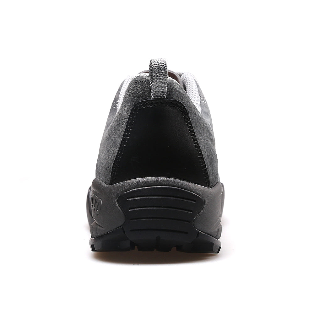 Gray athletic shoe with black sole on a white background