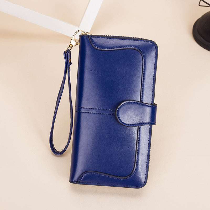 Blue wallet with a strap on a beige background