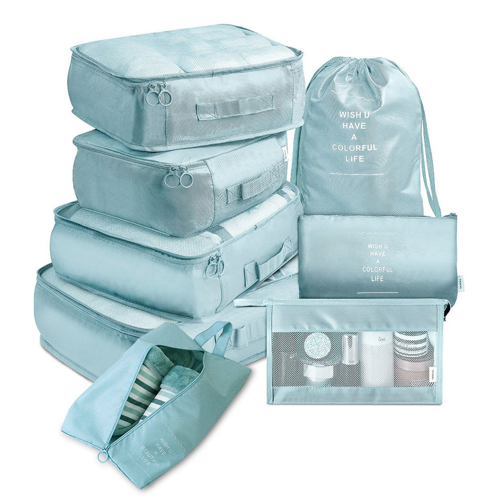 Set of light blue packing cubes and bags on a white background