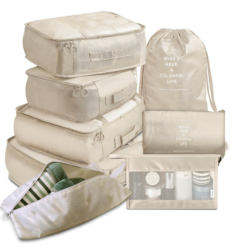 Set of beige travel packing cubes and bags on a white background