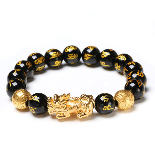 Black beaded bracelet with gold dragon charm on a white background