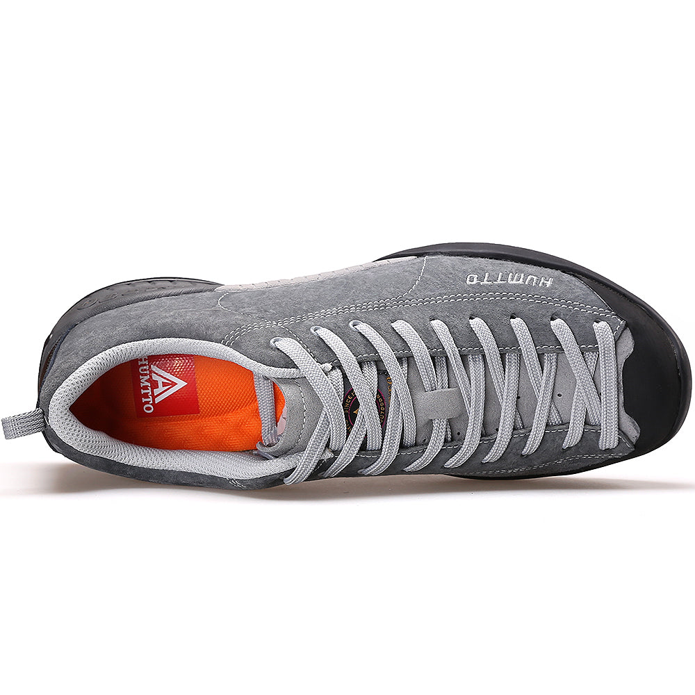 Gray climbing shoe with white laces on a white background