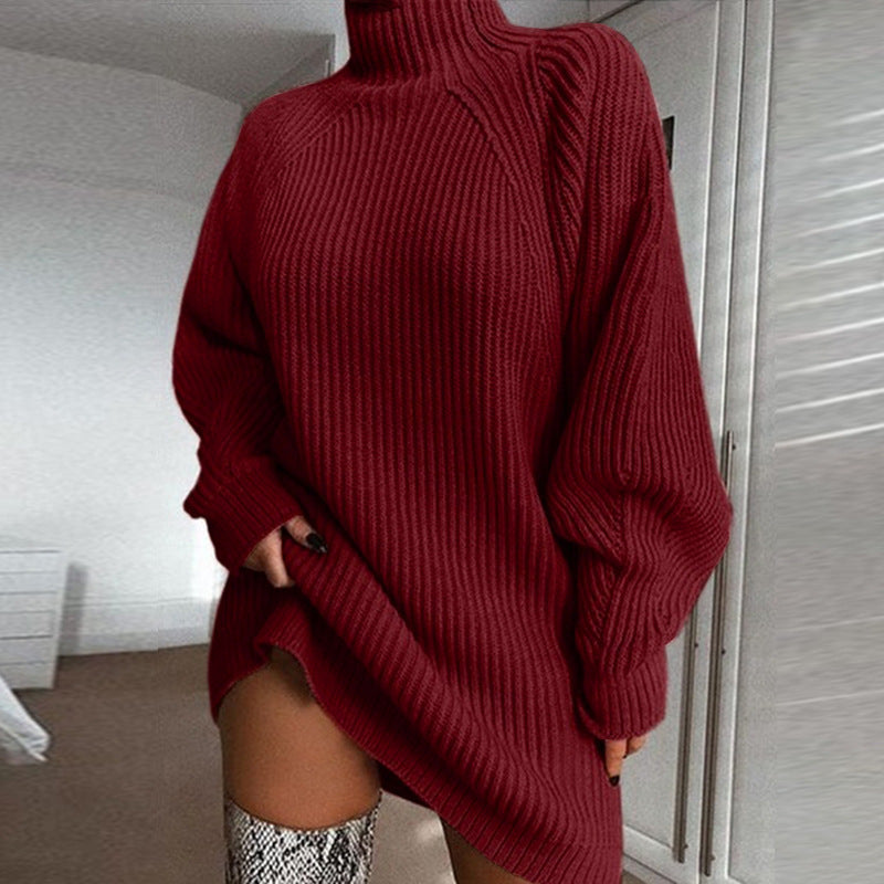 Person wearing a red sweater with a high neckline in an indoor setting.
