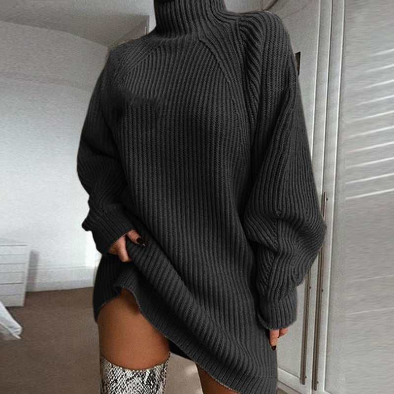 Person wearing a dark gray oversized sweater in an indoor setting