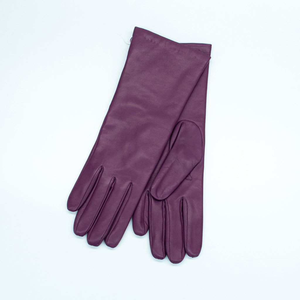 Pair of purple gloves on a light gray background