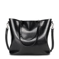 Women's retro oil wax leather tote bag in black, front view on white background with dual handles and adjustable crossbody strap