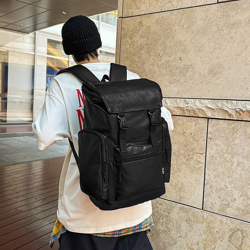 Person wearing a black backpack in an urban setting