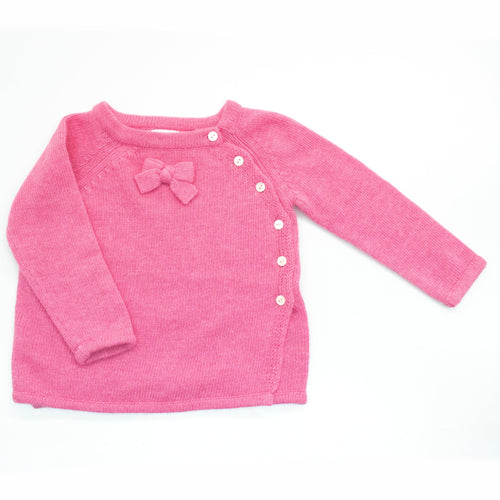 Pink baby sweater with a bow on a white background