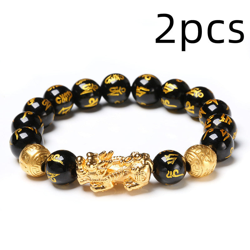 Black beaded bracelet with gold dragon charm and '2pcs' text on a white background