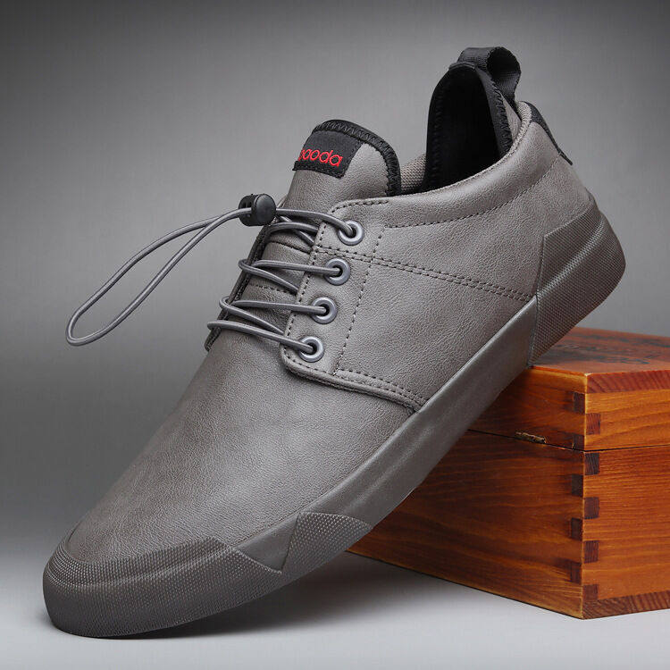 Gray sneaker with a brand logo on a gray background
