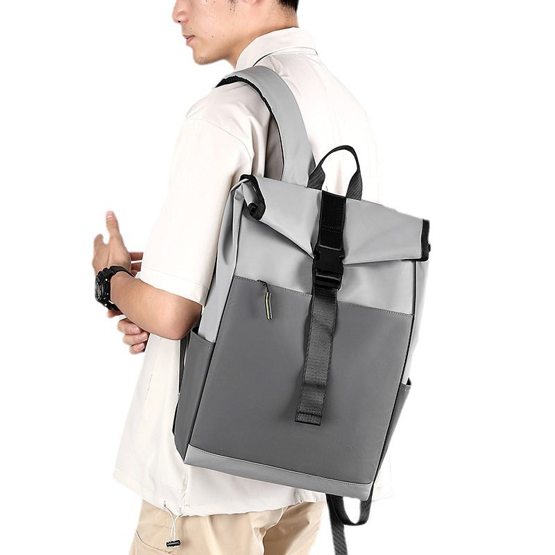 Person wearing a gray backpack on a white background