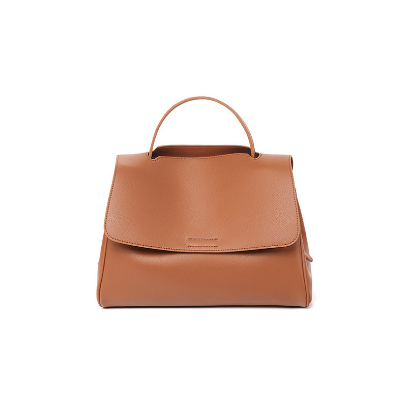 Brown leather handbag on a white background