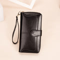 Black wallet with a strap on a beige background