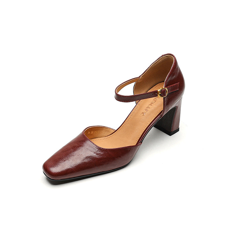 A single women's Mary Jane pump shoe in glossy burgundy leather with a block heel and ankle strap, shown on a plain white background.