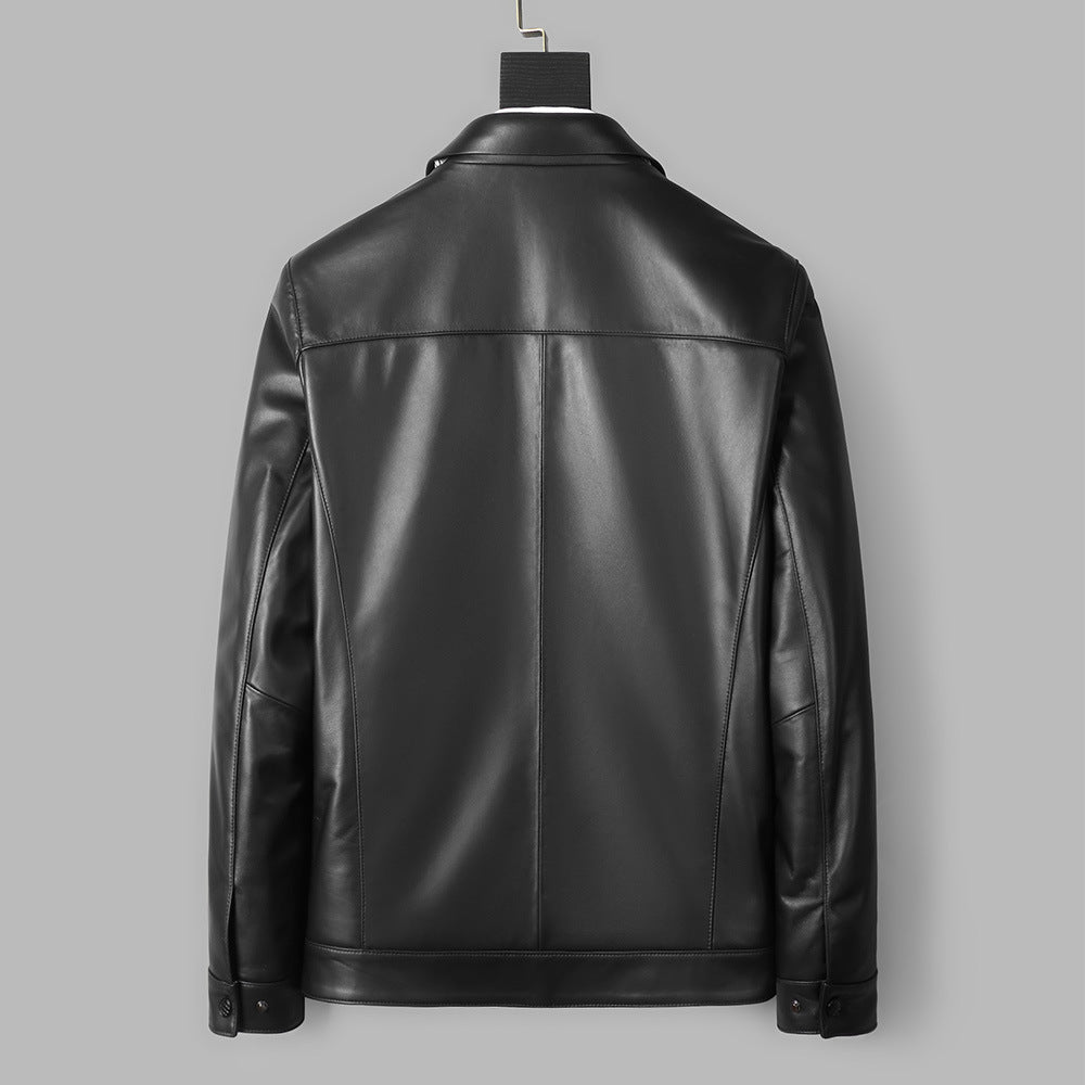 Black leather jacket shown from the back on a hanger against a solid gray background.