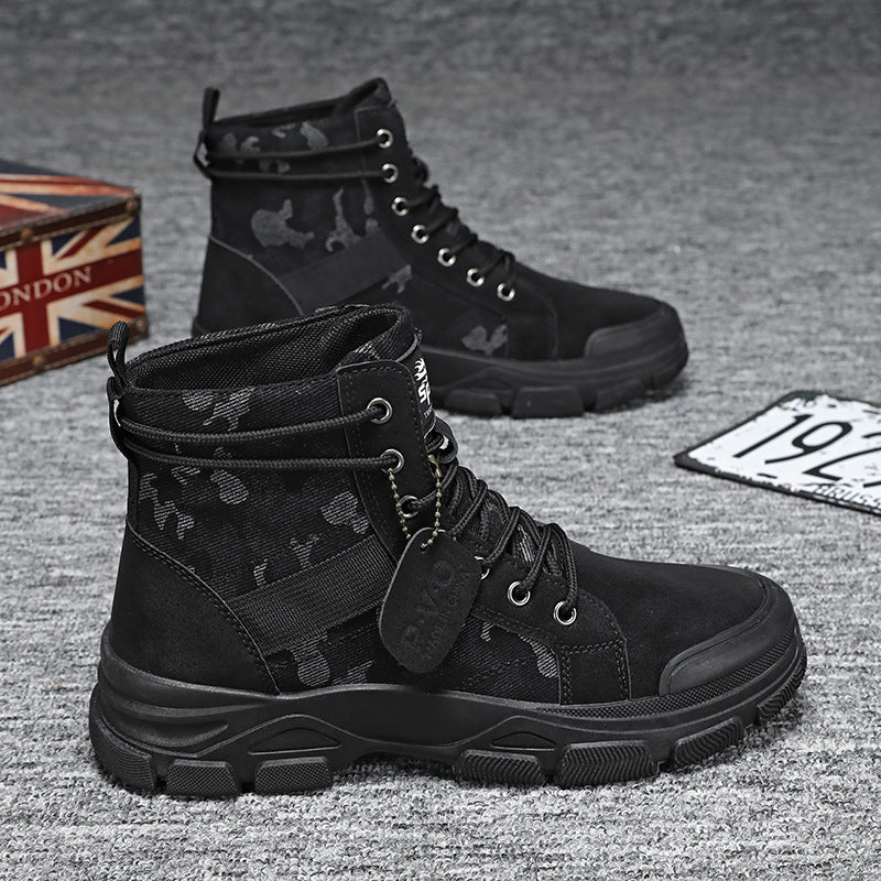 Black tactical boots with camouflage patterns on a textured surface