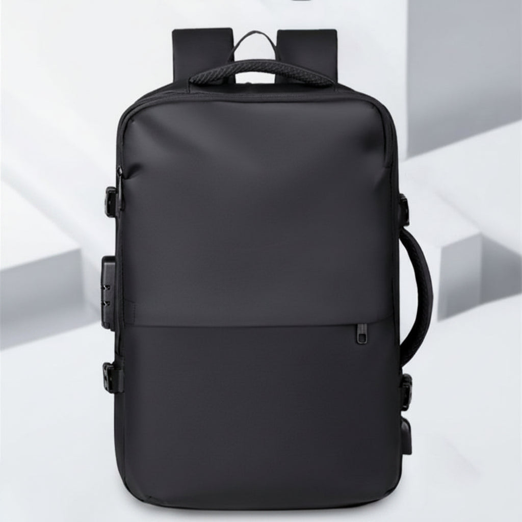 A black minimalist backpack with a top carry handle, side compression straps, and a front zippered pocket, shown against a clean white geometric background.