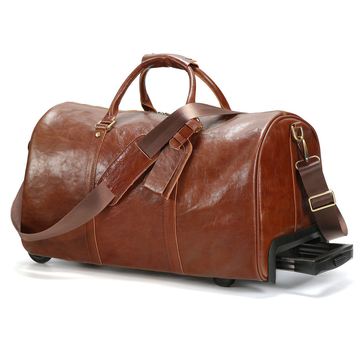 A brown leather duffel bag with dual top handles, an adjustable shoulder strap, and a black wheeled base, photographed on a clean white background.