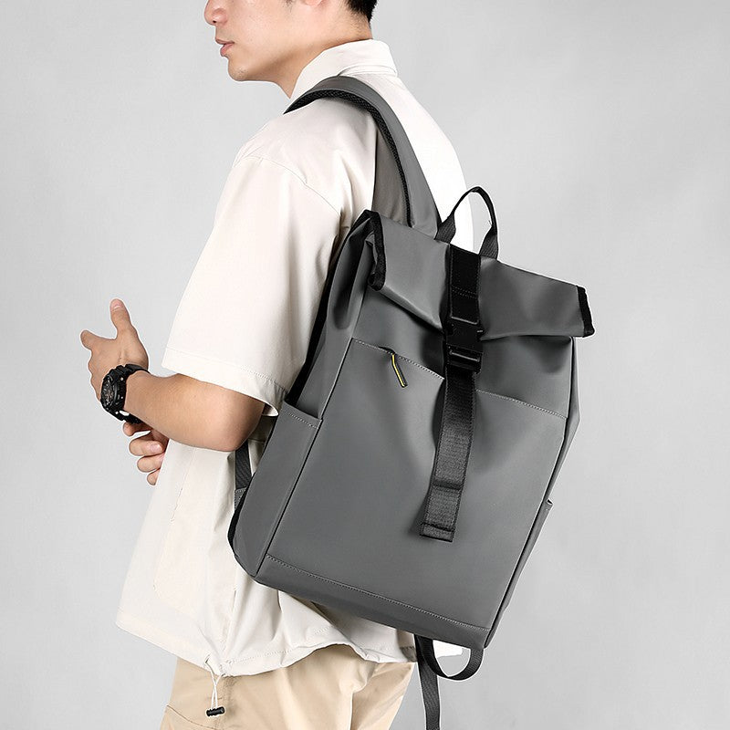 Person wearing a gray backpack on a plain background