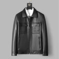 Black leather jacket with textured panels on a gray background