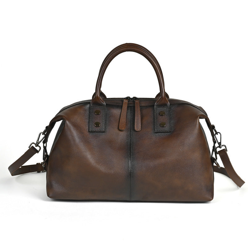 Brown leather handbag with straps on a white background