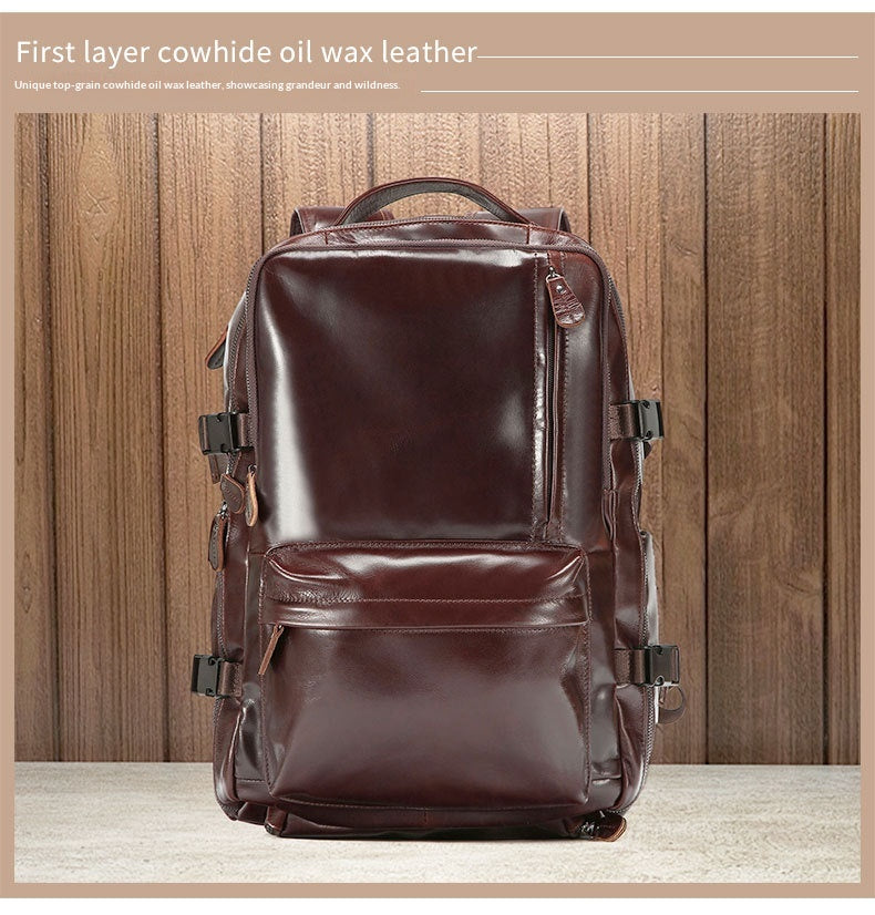 A dark brown leather backpack shown from the front, standing on a light surface against a wood plank wall. Small text appears at the top describing the material.
