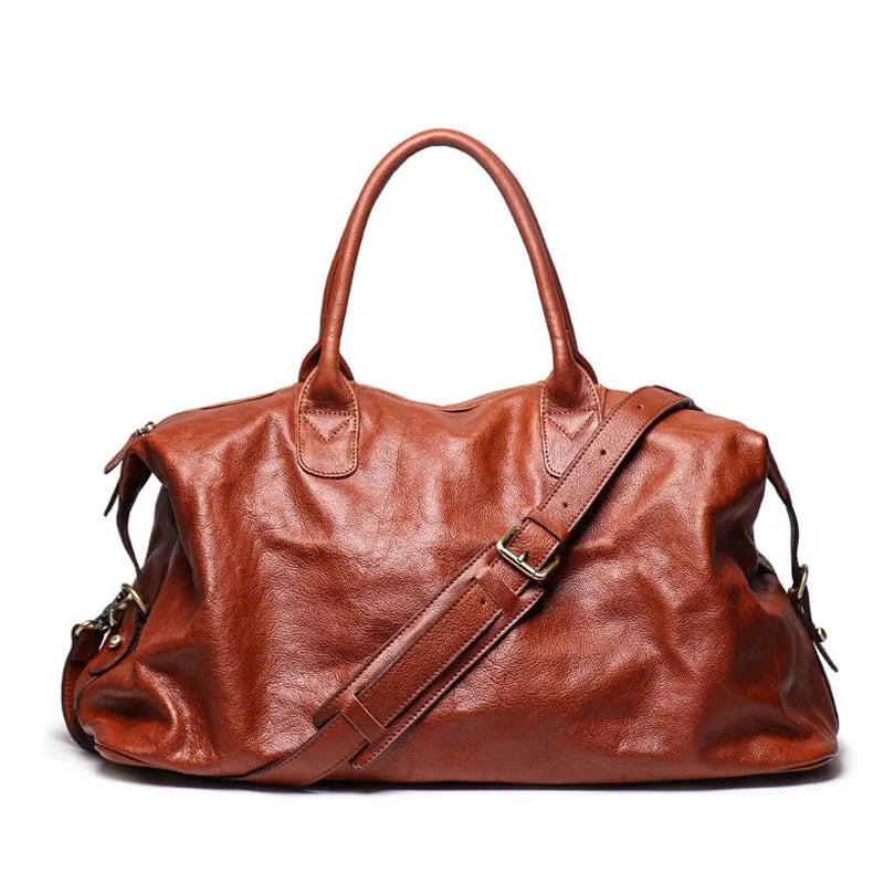 A brown textured leather duffel bag with dual top handles and an adjustable shoulder strap, shown on a plain white background.
