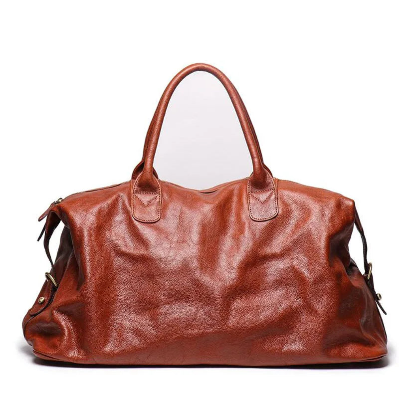 A large brown leather duffel bag with double top handles, photographed against a plain white background.