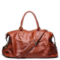 Brown leather bag with a shoulder strap on a white background