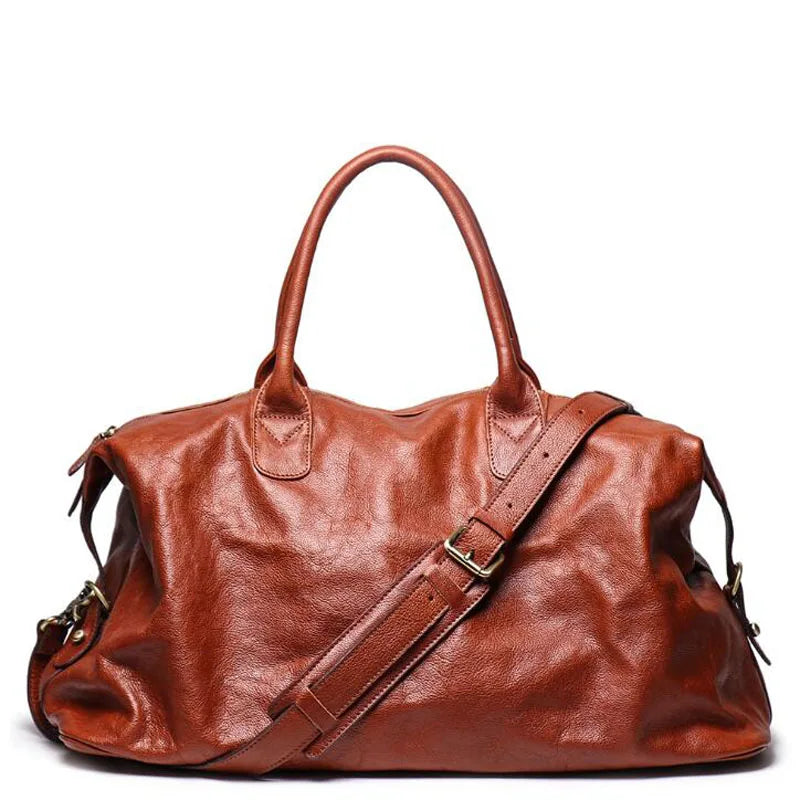 Brown leather bag with a shoulder strap on a white background