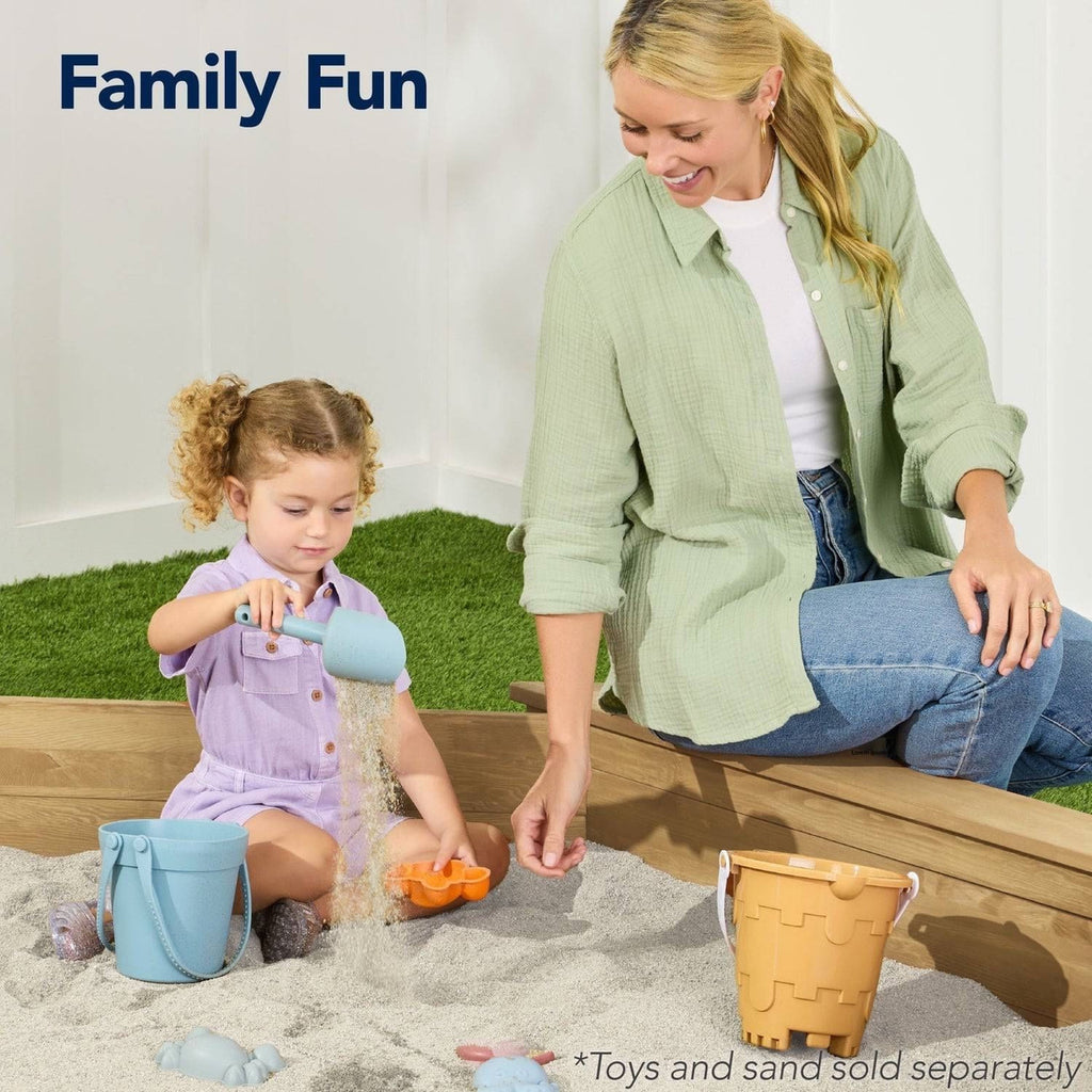 Woman and child playing in a sandbox with toys and sand, text 'Family Fun' above.