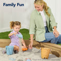 Woman and child playing in a sandbox with toys and sand, text 'Family Fun' above.