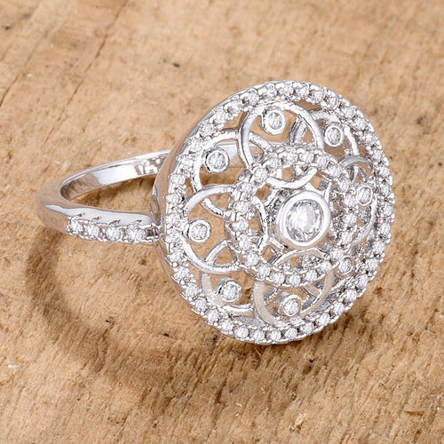 Silver ring with intricate design on a wooden surface