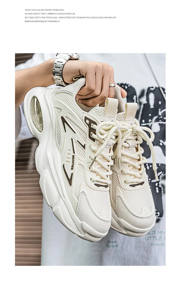 White sneakers held by a person with a blurred background