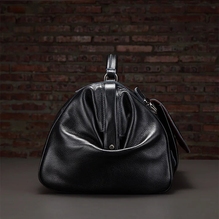 Black leather handbag against a brick wall background
