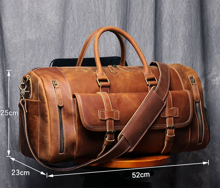 Brown leather duffel bag with measurements on a gray background