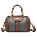 Gray handbag with brown accents and a visible brand logo on a white background
