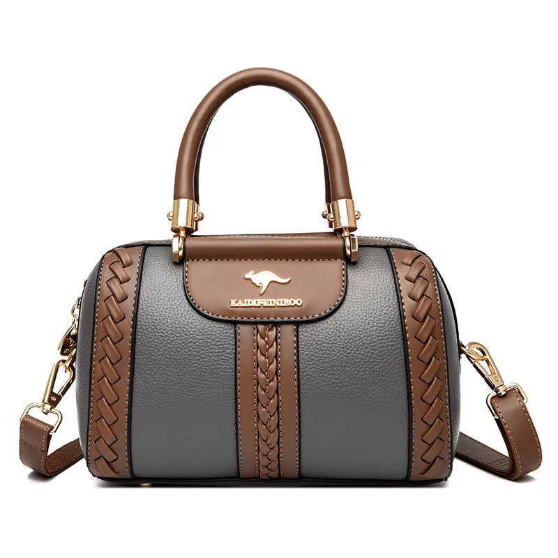Gray handbag with brown accents and a visible brand logo on a white background