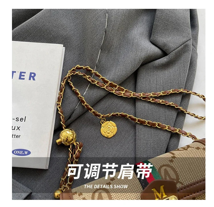 Gold chain with decorative elements on a gray suit jacket
