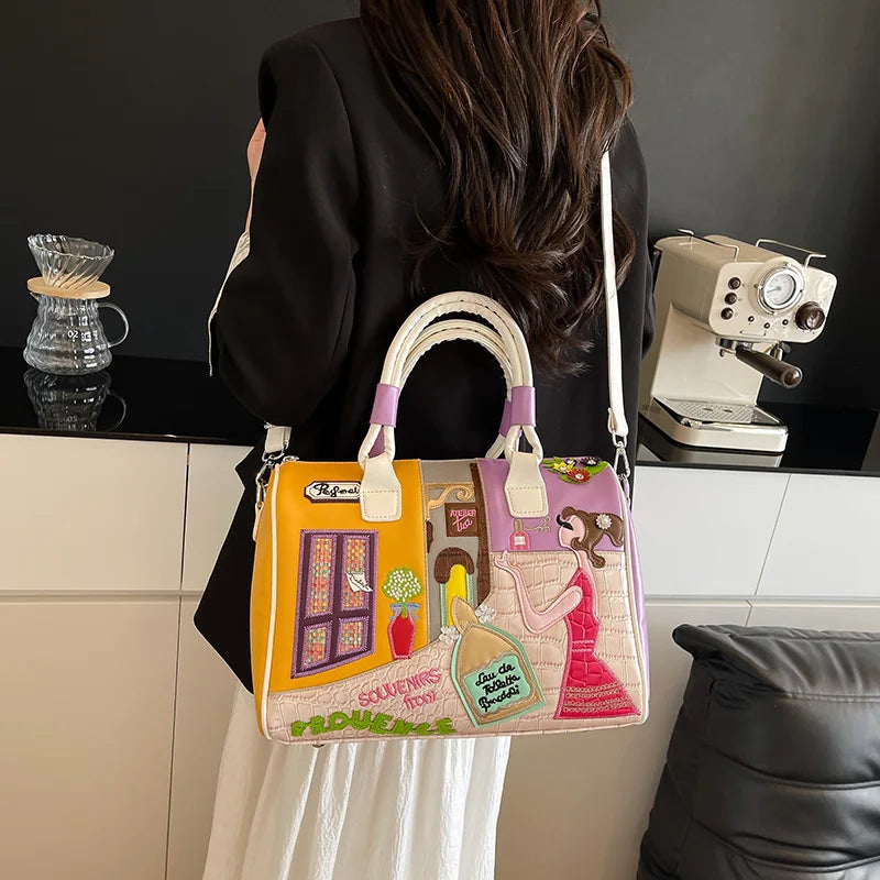 Person holding a colorful handbag with artistic design in a kitchen setting