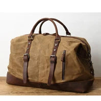 Brown leather duffel bag with brown straps on a wooden surface