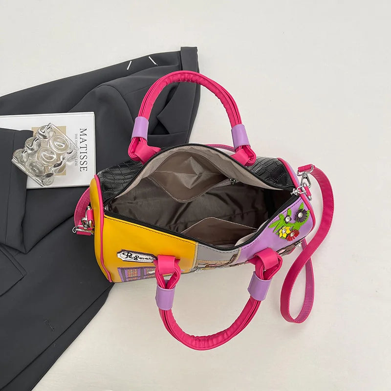 Colorful handbag with pink handles on a white background
