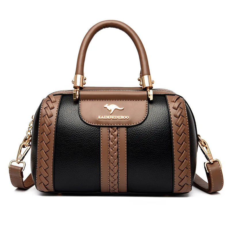 Black handbag with brown accents and a visible brand logo on a white background