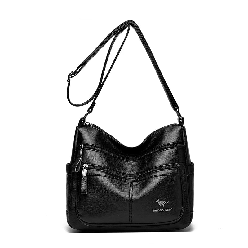 Black faux-leather shoulder bag with multiple zippered pockets and a small kangaroo logo on the front, shown on a plain white background.