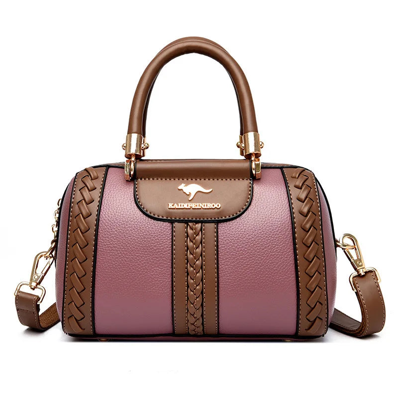 Brown and pink handbag with braided details on a white background
