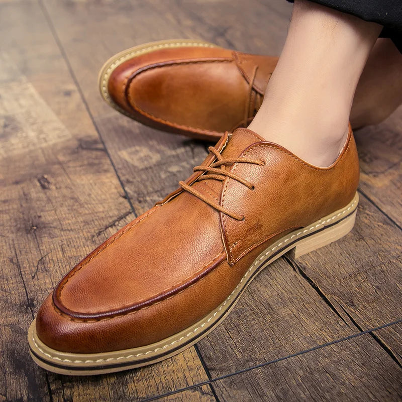 Brown leather shoes on a wooden floor
