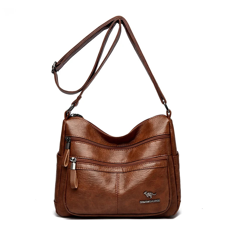 Brown leather handbag with a visible brand logo on a white background