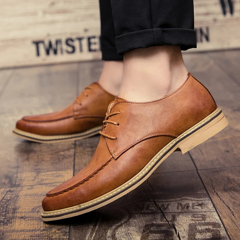 Brown leather shoes on a textured floor with 'Twisted' branding.