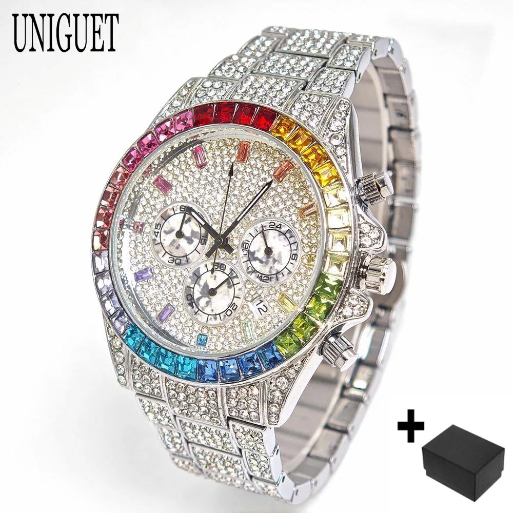 A silver-toned UNIGUET watch covered in rhinestones, featuring a rainbow-colored bezel with red, orange, yellow, green, blue, and purple stones. The watch has three sub-dials and a matching crystal-encrusted metal link bracelet.
