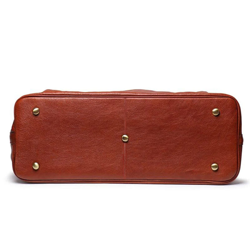Brown leather duffel bag with gold rivets on a white background